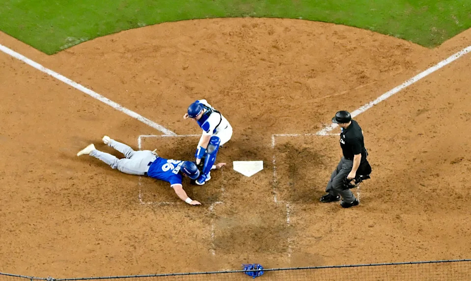 Los Angeles,  - October 27:  Catcher Will Smith #16 of the Los Angeles Dodgers tags out Davis Schneider #36 of the Toronto blueJays at home plate in the tenth inning of game 3 of a World Series baseball game at Dodger Stadium in Los Angeles on Monday, October 27, 2025.  (Photo by Keith Birmingham/MediaNews Group/Pasadena Star-News via Getty Images)