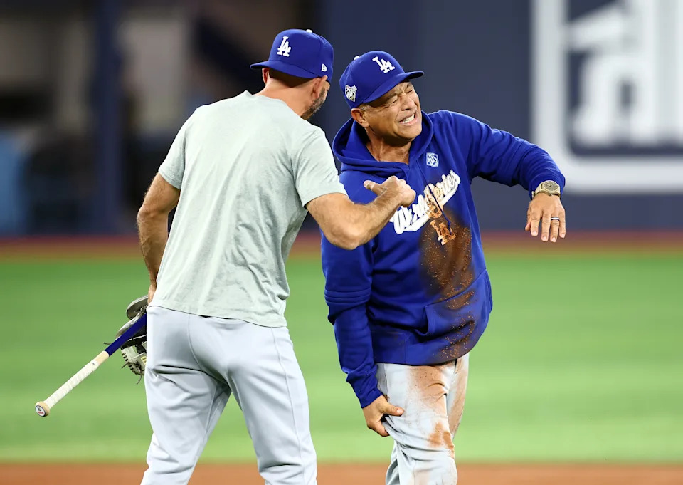 TORONTO, ON - OCTOBER 30:  Manager Dave Roberts of the Los Angeles Dodgers reacts after falling on the ground between second and third base while having a running race with Hyeseong Kim #6 during a workout day ahead of game six of the 2025 World Series at Rogers Centre on October 30, 2025 in Toronto, Ontario, Canada.  (Photo by Vaughn Ridley/Getty Images)
