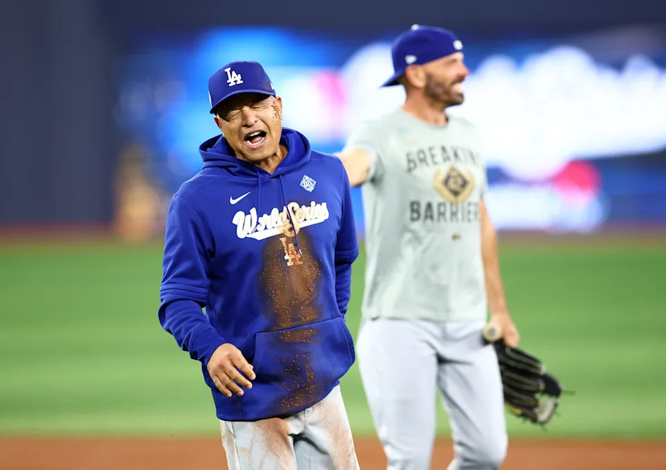 TORONTO, ON - OCTOBER 30:  Manager Dave Roberts of the Los Angeles Dodgers reacts after falling on the ground between second and third base while having a running race with Hyeseong Kim #6 during a workout day ahead of game six of the 2025 World Series at Rogers Centre on October 30, 2025 in Toronto, Ontario, Canada.  (Photo by Vaughn Ridley/Getty Images)