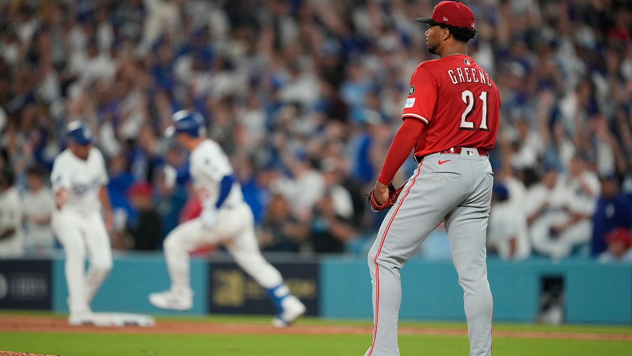 Cincinnati Reds starting pitcher Hunter Greene stands off the mound after giving up a solo home run to Los Angeles Dodgers' Tommy Edman during the third inning in Game 1 of the National League Wild Card baseball playoff series Tuesday, Sept. 30, 2025, in Los Angeles. (AP Photo/Mark J. Terrill)