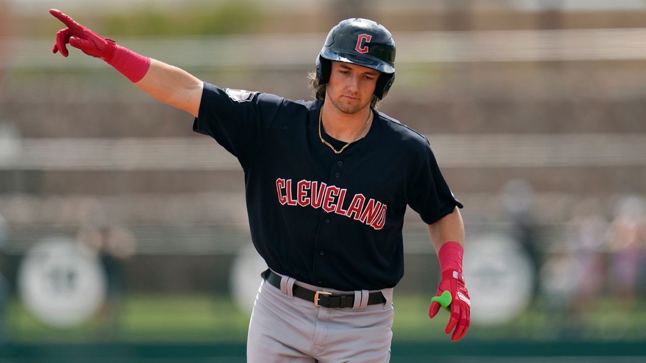 Cleveland Guardians' Chase DeLauter points as he rounds the bases after hitting a three-run home run against the Chicago White Sox during the first inning of a spring training baseball game, March 18, 2024, in Phoenix. (AP Photo/Ross D. Franklin)