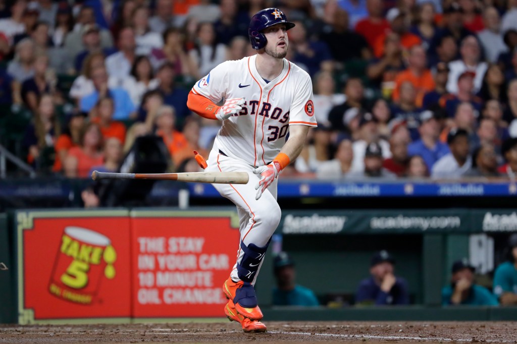 Astros' Kyle Tucker flips his bat as he watches his solo home run 