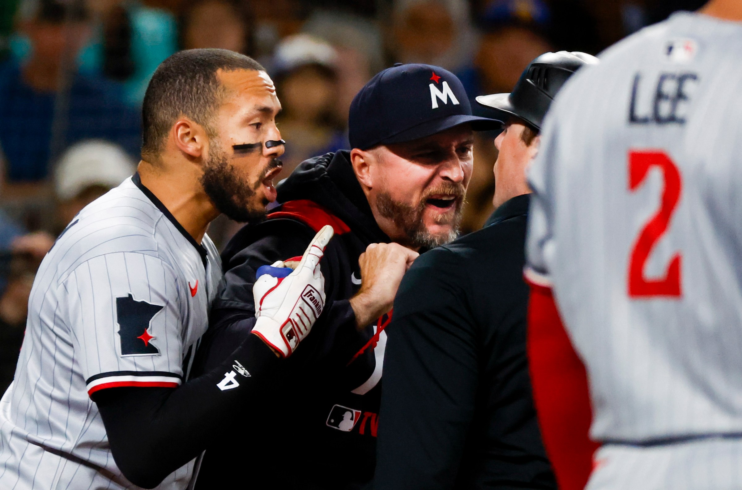 May 31, 2025; Seattle, Washington, USA; Minnesota Twins shortstop Carlos Correa (4, left) and manager Rocco Baldelli (5, middle) argue with umpire Austin Jones (right) during the seventh inning against the Seattle Mariners at T-Mobile Park. Correa and Baldelli were both ejected from the game. Mandatory Credit: Joe Nicholson-Imagn Images