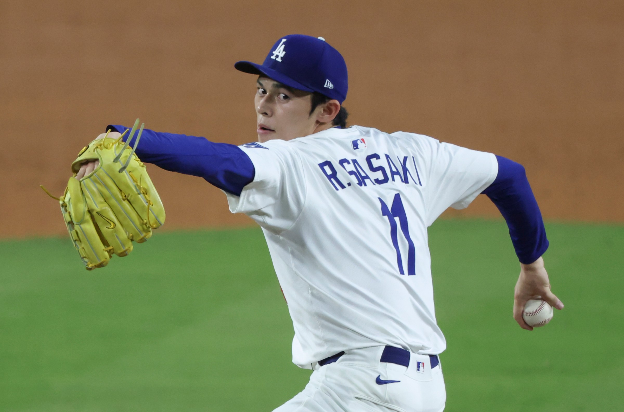 Oct 17, 2025; Los Angeles, California, USA; aLos Angeles Dodgers pitcher Roki Sasaki (11) throws against the Milwaukee Brewers during the ninth inning in game four of the NLCS round for the 2025 MLB playoffs at Dodger Stadium. Mandatory Credit: Kiyoshi Mio-Imagn Images