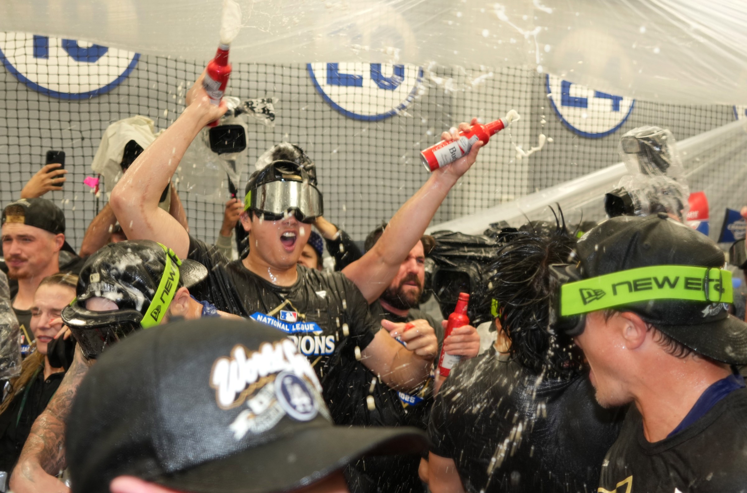 Oct 17, 2025; Los Angeles, California, USA; Los Angeles Dodgers two-way player Shohei Ohtani (17) celebrates with teammates in the clubhouse after defeating the Milwaukee Brewers in game four of the NLCS round for the 2025 MLB playoffs at Dodger Stadium. Mandatory Credit: Kirby Lee-Imagn Images