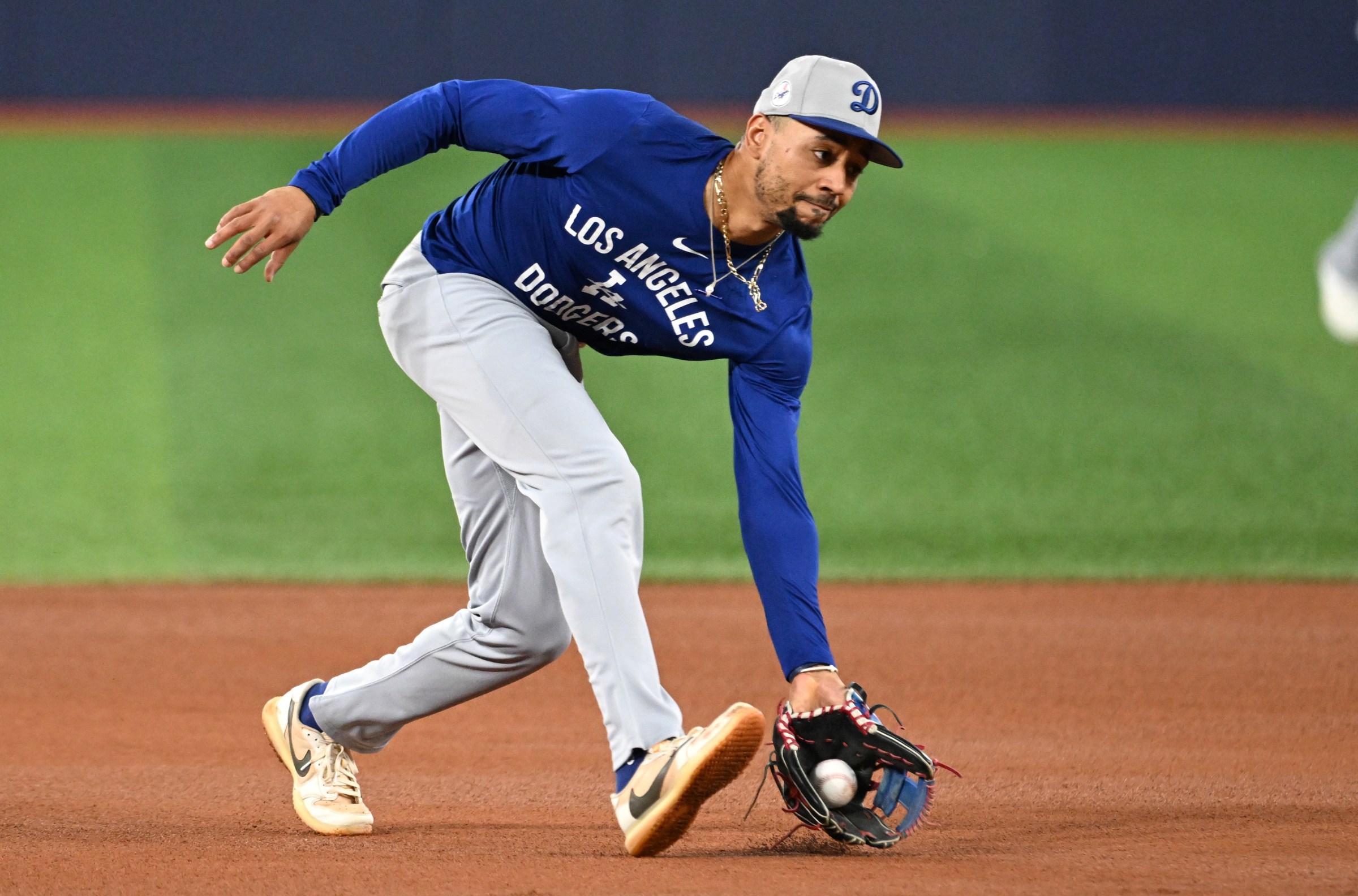 Oct 23, 2025; Toronto, ON, Canada; Los Angeles Dodgers shortstop Mookie Betts (50) fields a ground ball during World Series team workouts at Rogers Centre. Mandatory Credit: Dan Hamilton-Imagn Images