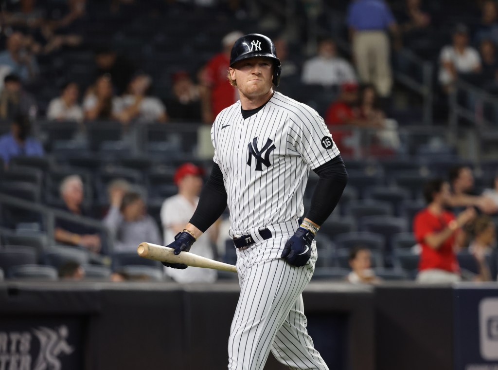 New York Yankees pinch hitter Clint Frazier #77 walks back to the dugout after striking out in the 7th inning.