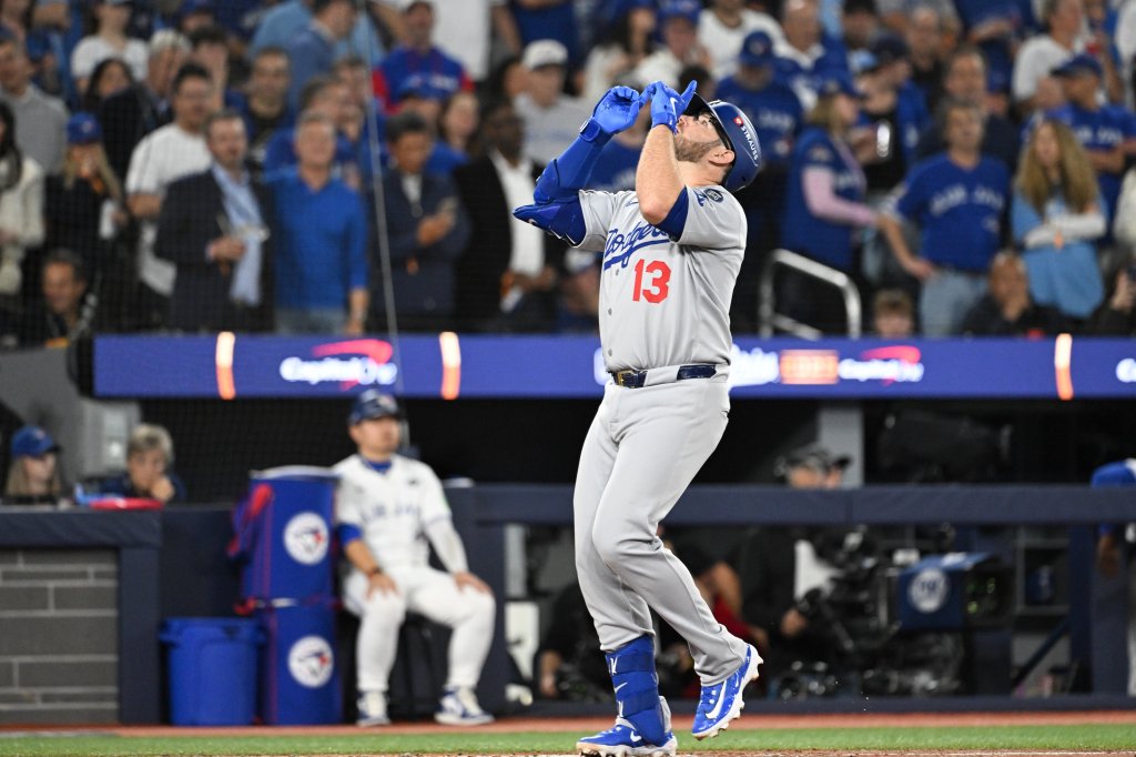 Los Angeles Dodgers third baseman Max Muncy celebrating after hitting a solo home run.