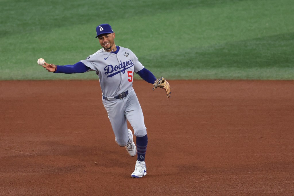 Mookie Betts of the Los Angeles Dodgers throwing to first base for an out against the Toronto Blue Jays.