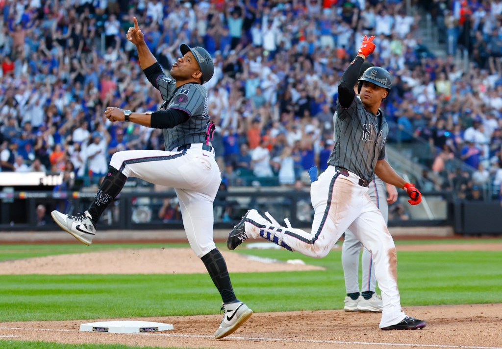 New York Mets first base coach Antoan Richardson reacts to a home run by Juan Soto.
