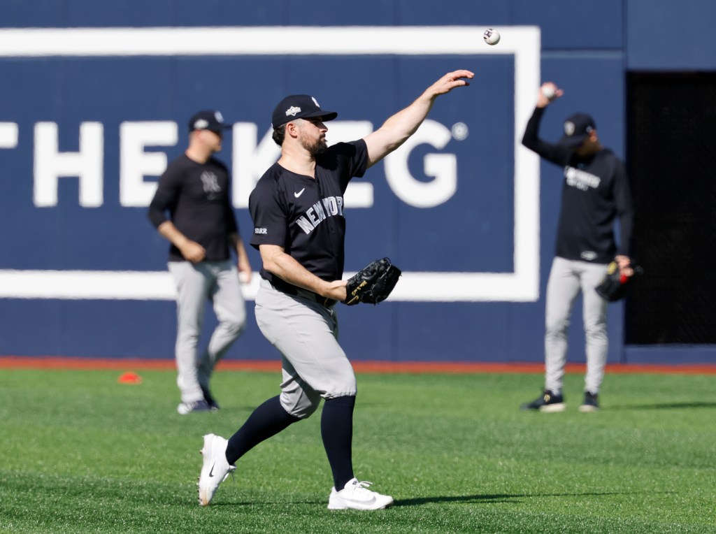 New York Yankees pitcher Carlos Rodón throws during batting practice.