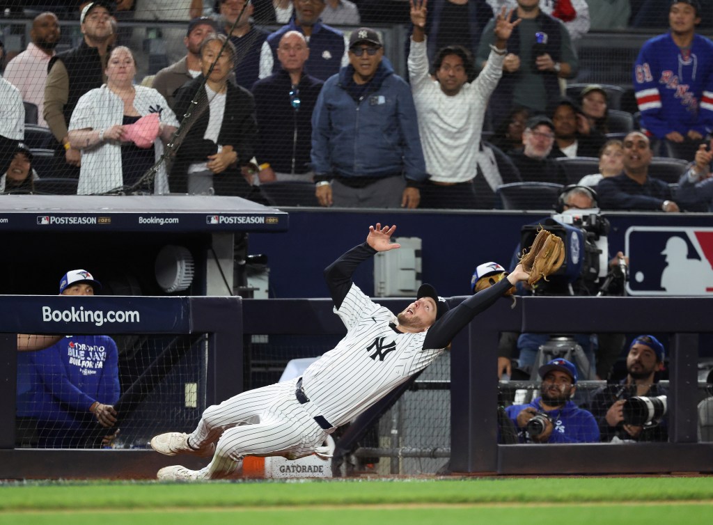 Yankees third baseman Ryan McMahon #19 makes a catch on a pop up by Toronto Blue Jays right fielder Anthony Santander during the ALDS.