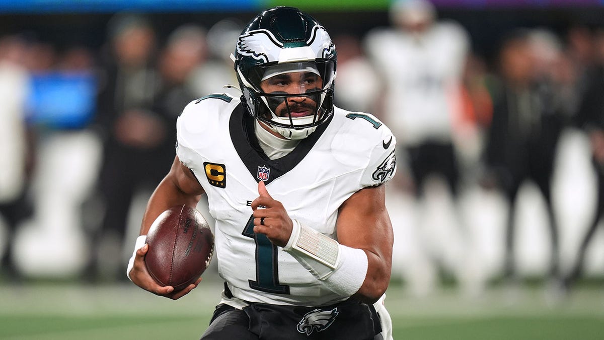 Jalen Hurts carries the ball