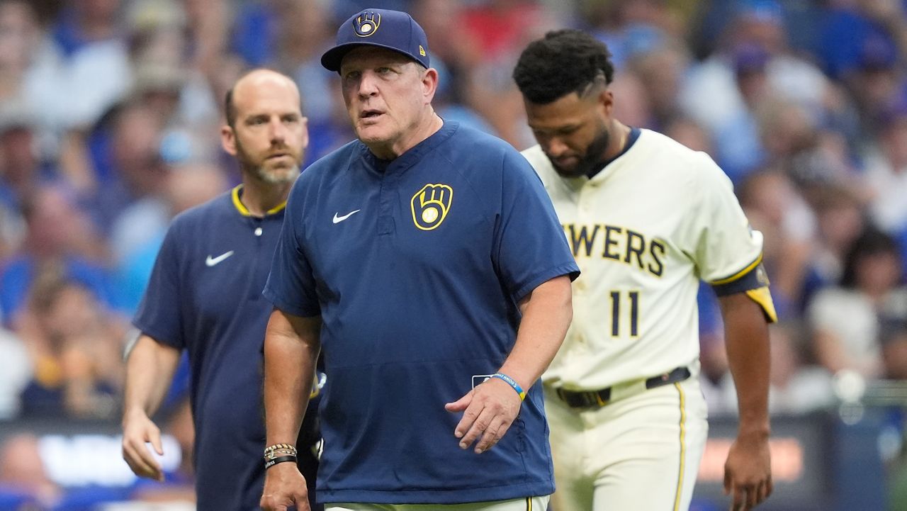 Milwaukee Brewers manager Pat Murphy, middle, walks to the dugout with Jackson Chourio (11) during the fifth inning of a baseball game against the Chicago Cubs, Tuesday, July 29, 2025, in Milwaukee. Chourio was removed from the game after suffering an injury. (AP Photo/Aaron Gash)