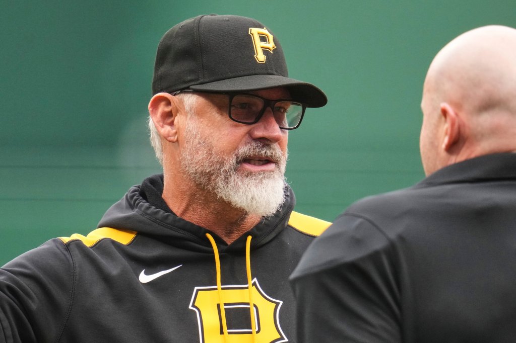 Pirates manager Derek Shelton, left, talks with umpire Mike Estabrook between innings of a baseball game against the San Diego Padres in Pittsburgh, Saturday, May 3, 2025. 