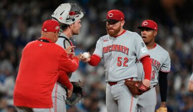Cincinnati Reds manager Terry Francona, left, walks up to mound to replace starting pitcher Zack Littell (52) during the fourth inning in Game 2 of the National League Wild Card baseball playoff series against the Los Angeles Dodgers, Wednesday, Oct. 1, 2025, in Los Angeles. (AP Photo/Mark J. Terrill)