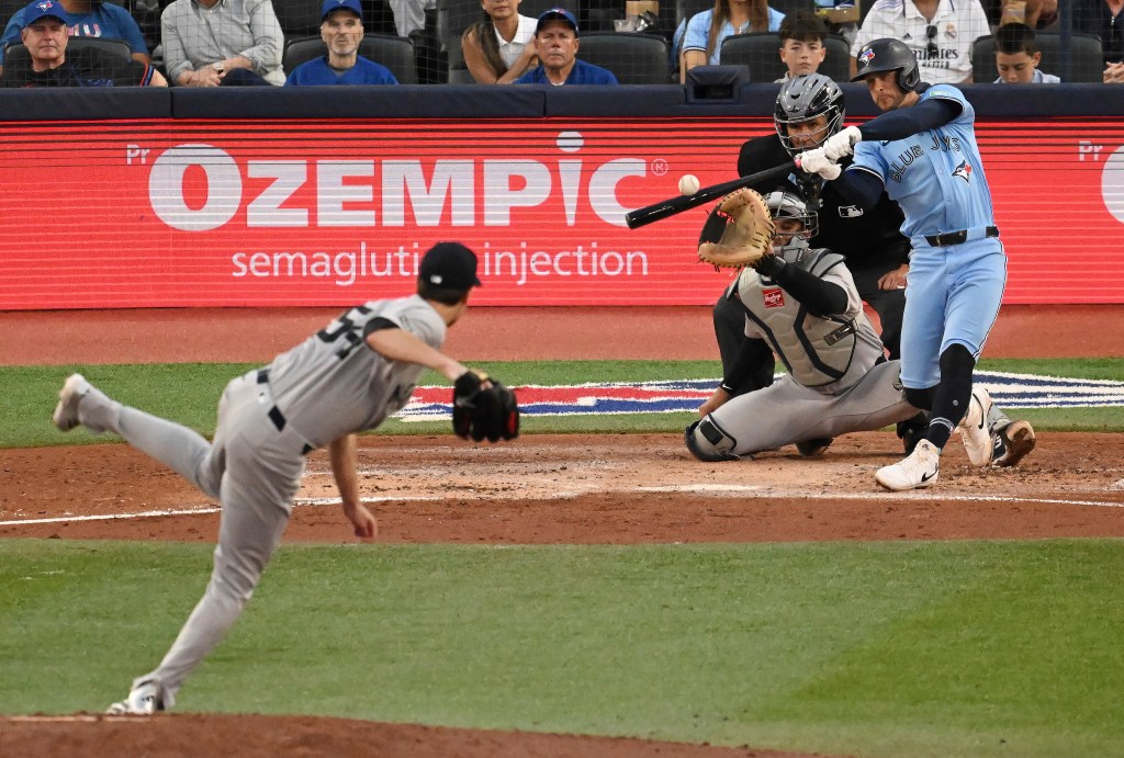 Toronto Blue Jays' Ernie Clement hits an RBI single off New York Yankees starting pitcher Max Fried in Toronto.