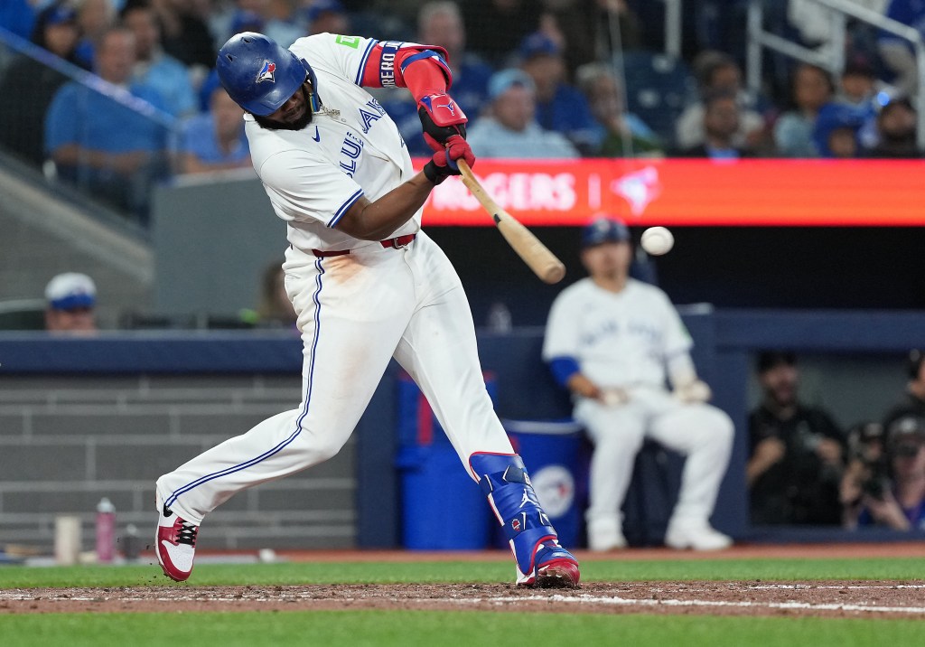 Vladimir Guerrero Jr. (27) hitting a single.