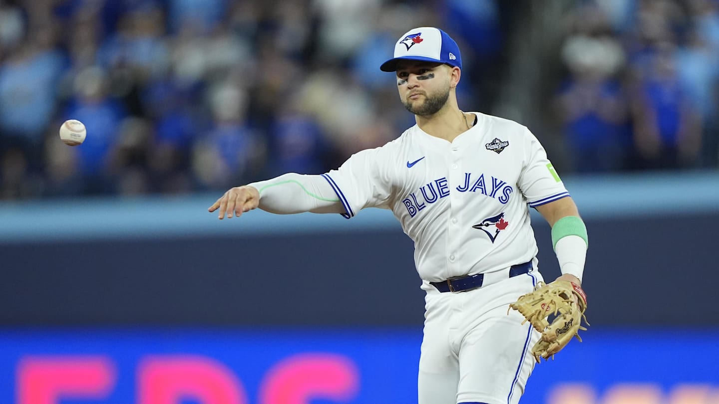 Nov 1, 2025; Toronto, Ontario, CAN; Toronto Blue Jays designated hitter Bo Bichette (11) throws to first for an out against Los Angeles Dodgers second baseman Tommy Edman (25) in the eighth inning during game seven of the 2025 MLB World Series at Rogers Centre. Mandatory Credit: John E. Sokolowski-Imagn Images