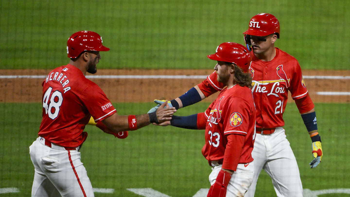 May 23, 2025; St. Louis, Missouri, USA;  St. Louis Cardinals designated hitter Ivan Herrera (48) right fielder Lars Nootbaar (21) and left fielder Brendan Donovan (33) celebrate after they scored on a three run triple by third baseman Nolan Arenado (not pictured) during the sixth inning against the Arizona Diamondbacks at Busch Stadium. Mandatory Credit: Jeff Curry-Imagn Images