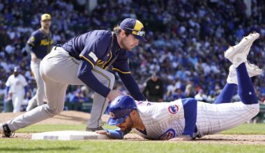 May 5, 2024; Chicago, Illinois, USA; Chicago Cubs outfielder Mike Tauchman (40) dives safely into first base as Milwaukee Brewers third base Tyler Black (7) makes a late tag during the seventh inning at Wrigley Field. Mandatory Credit: David Banks-Imagn Images