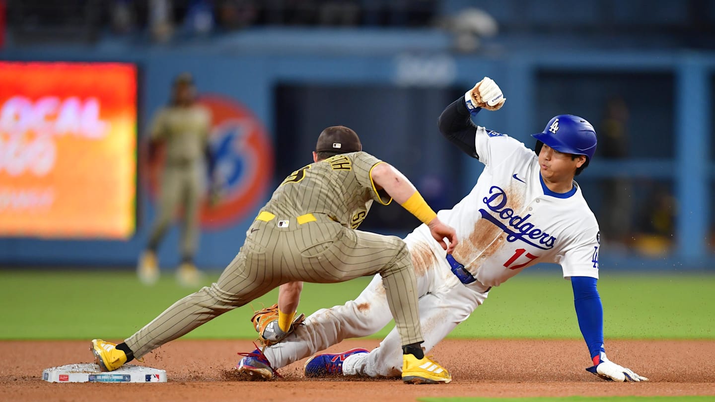 Aug 15, 2025; Los Angeles, California, USA;  Los Angeles Dodgers designated hitter Shohei Ohtani (17) is caught stealing by San Diego Padres second base Jake Cronenworth (9) during the third inning at Dodger Stadium. Mandatory Credit: Gary A. Vasquez-Imagn Images