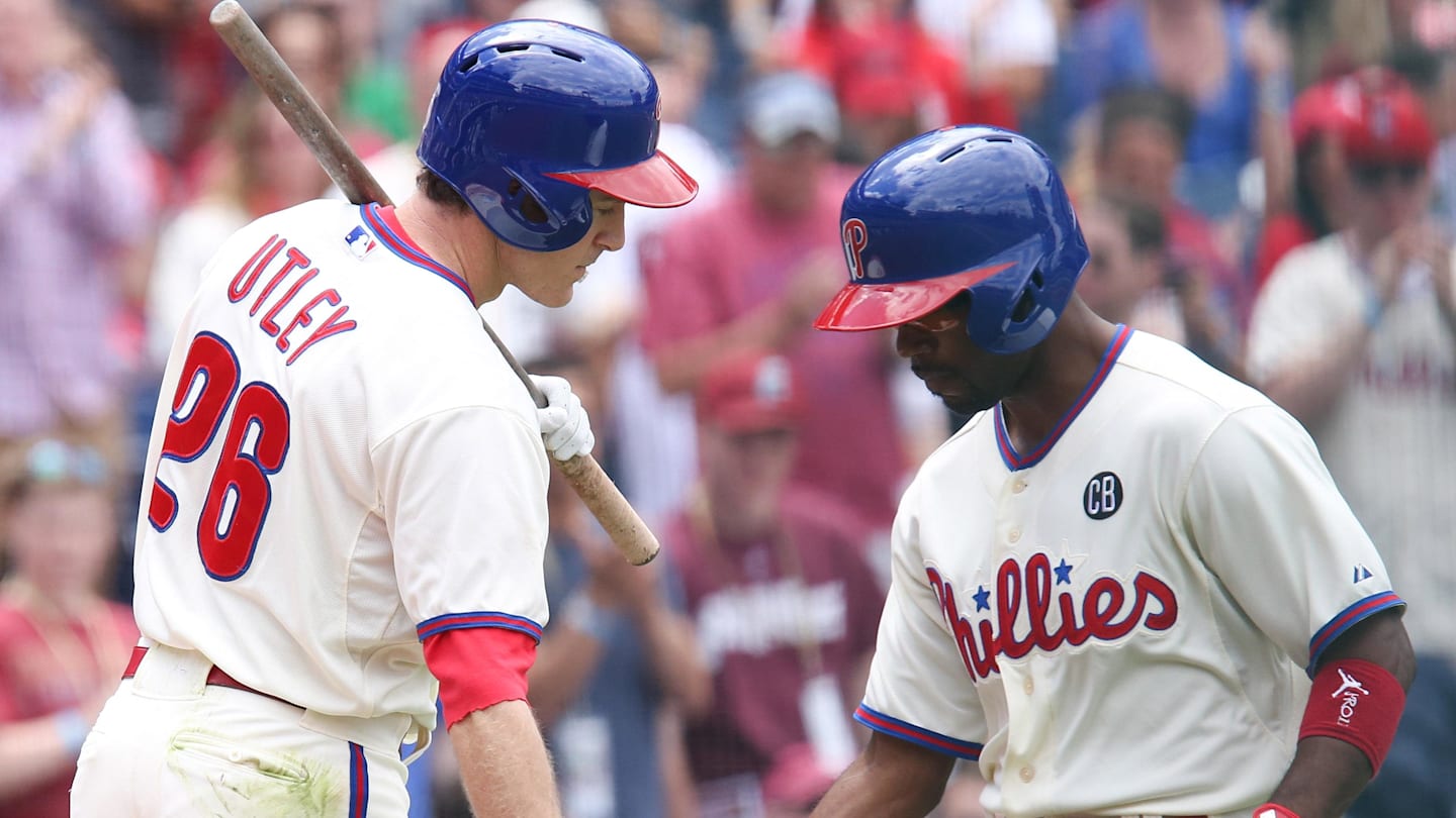 May 18, 2014; Philadelphia, PA, USA; Philadelphia Phillies shortstop Jimmy Rollins (11) celebrates with second baseman Chase Utley (26) after hitting a home run in the first inning against the Cincinnati Reds at Citizens Bank Park. Mandatory Credit: Bill Streicher-Imagn Images