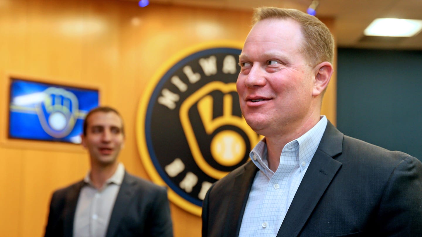 Matt Arnold, right, mingles with others following a press conference where it was announced that he would be taking over the role as president of baseball operations for the Milwaukee Brewers on, October 27, 2022. David Stearns, left, who joined the organization in October 2015 as general manager and was named president of baseball operations prior to the 2019 season, said he would be stepping down.