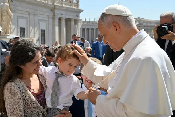 VATICAN CITY, VATICAN - JUNE 25:  (EDITOR NOTE: STRICTLY EDITORIAL USE ONLY - NO MERCHANDISING). Pope Leo XIV greets a child during his weekly general audience at St. Peter's Square on June 25, 2025 in Vatican City, Vatican. During his Wednesday General Audience, Pope Leo XIV shared that he continues to closely and hopefully follow the situation in Iran, Israel, and Palestine. (Photo by Simone Risoluti - Vatican Media via Vatican Pool/Getty Images)