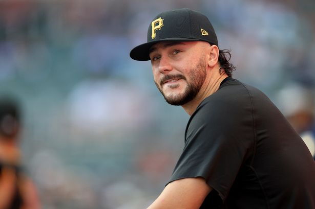 Paul Skenes looks on from the dugout