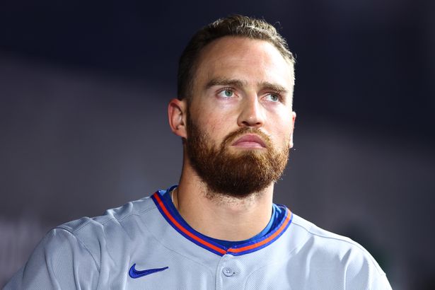 Brandon Nimmo stands in the dugout