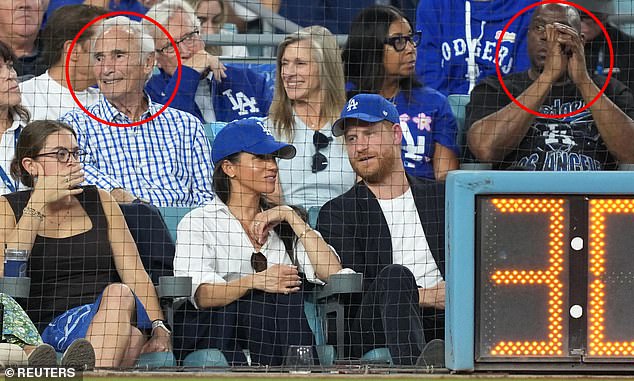 Some fans were also angered that the pair were sat in front of Sandy Koufax, circled left, and Magic Johnson, circled right
