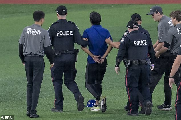 After being tackled to the floor by security he was eventually escorted off by police officers