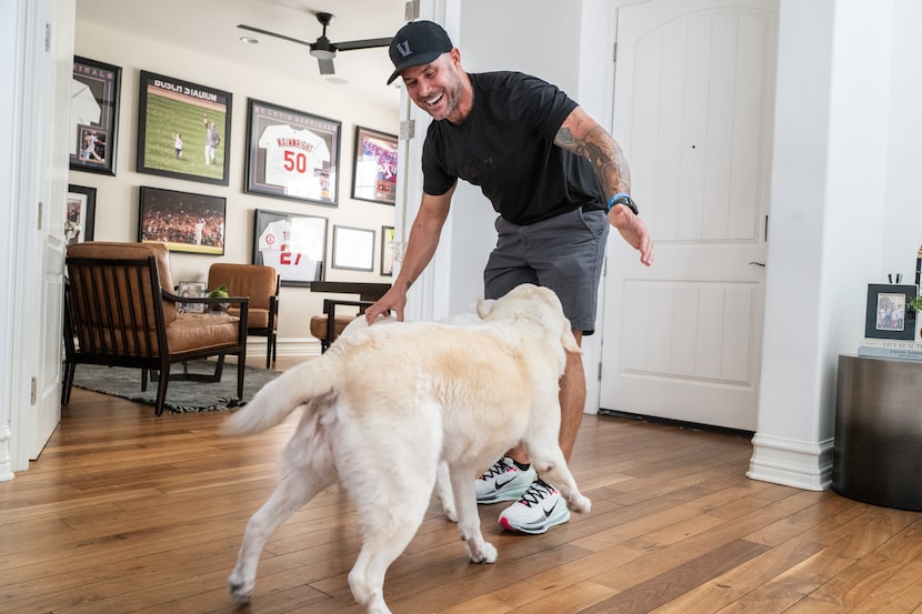Texas Rangers Manager Skip Schumaker greets his dogs Louie and Ribby at his home on...