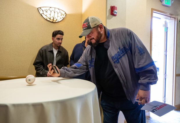 Los Angeles resident Luis Gomez takes a photo Friday, Nov....