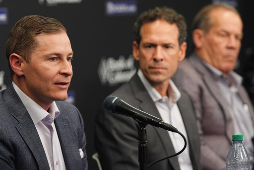 Walker Monfort, left, executive vice president of the Colorado Rockies, responds to a question as Paul DePodesta, the team