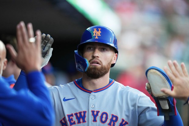 FILE - New York Mets' Brandon Nimmo celebrates in the dugout after scoring off of a sacrifice fly by Cedric Mullins during the fourth inning of a baseball game against the Detroit Tigers, Tuesday, Sept. 2, 2025, in Detroit. (AP Photo/Ryan Sun, File)