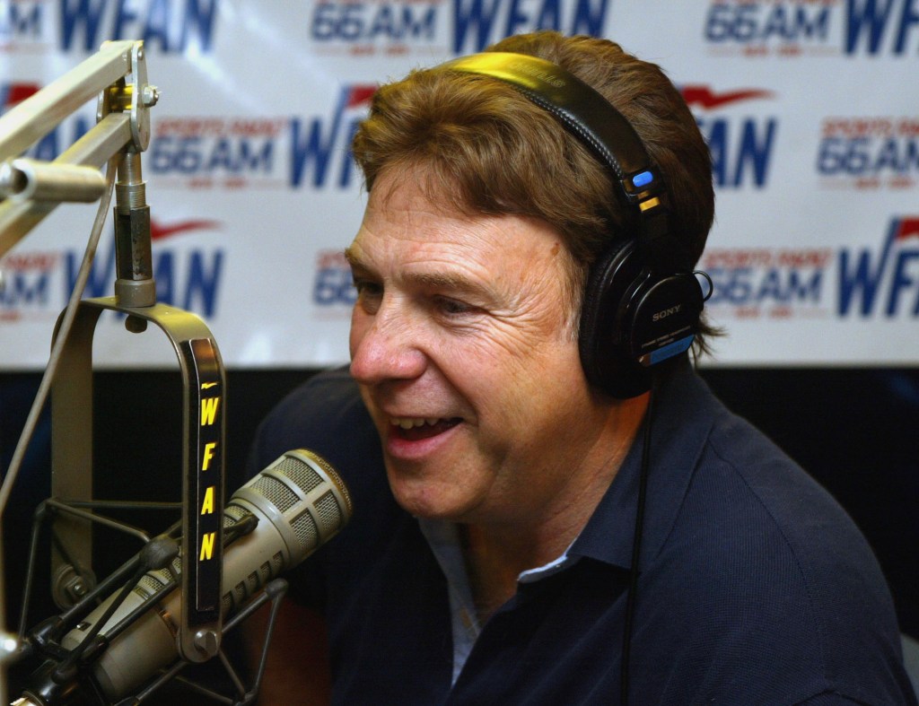 Richard Neer, an on-air personality for WFAN, speaks into a microphone while wearing headphones.