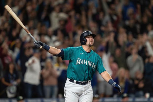 Seattle Mariners' Cal Raleigh watches his solo home run off Oakland Athletics relief pitcher Domingo Acevedo during the ninth inning of a baseball game Friday, Sept. 30, 2022, in Seattle. The Mariners won 2-1 to clinch a spot in the playoffs. (AP Photo/Stephen Brashear) (Stephen Brashear, AP)