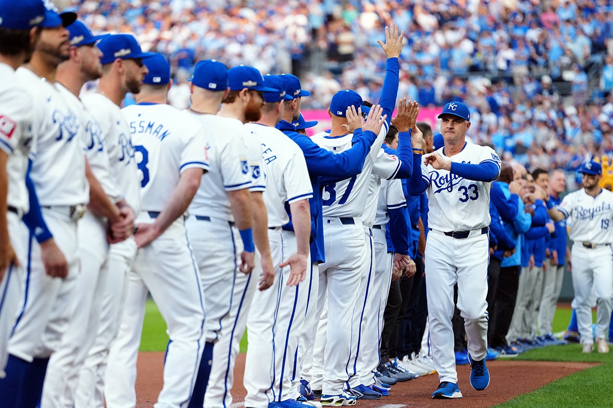Matt Quatraro high-fives players during pregame introduction