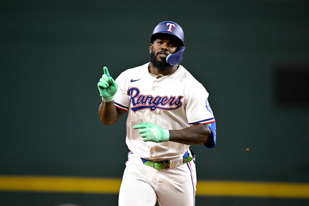 Adolis Garcia of the Texas Rangers celebrating after hitting a home run.