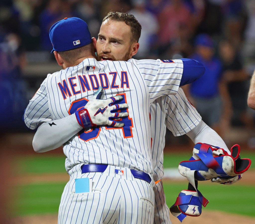 Mets outfielder Brandon Nimmo (9) wins the game with a walk-off hit during the ninth inning and hugs New York Mets manager Carlos Mendoza (64).
