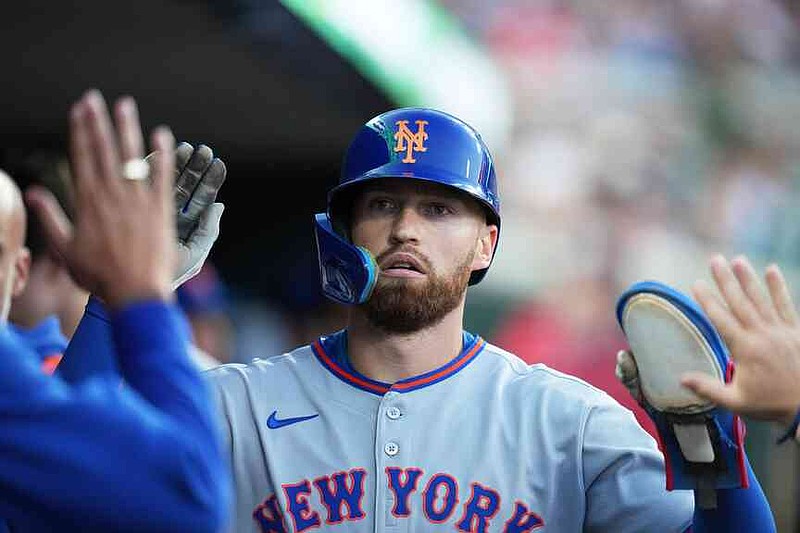 FILE - New York Mets' Brandon Nimmo celebrates in the dugout after scoring off of a sacrifice fly by Cedric Mullins during the fourth inning of a baseball game against the Detroit Tigers, Tuesday, Sept. 2, 2025, in Detroit. (AP Photo/Ryan Sun, File)