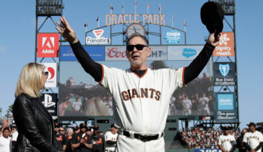San Francisco Giants manager Bruce Bochy, center, gestures toward fans next to his wife Kim during a ceremony honoring Bochy after a game between the Giants and the Los Angeles Dodgers. (Jeff Chiu/AP)