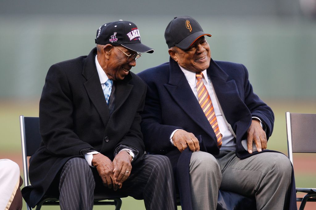 Willie Mays chats with former teammate Bill Greason during his 80th birthday celebration