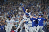 Los Angeles Dodgers pitcher Yoshinobu Yamamoto, top, and catcher Will Smith celebrate after...