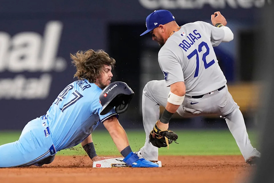 Los Angeles Dodgers' Miguel Rojas, forces Toronto Blue Jays' Addison Barger out at second base to end Game 6 of baseball's World Series, Friday, Oct. 31, 2025, in Toronto. (AP Photo/Brynn Anderson)