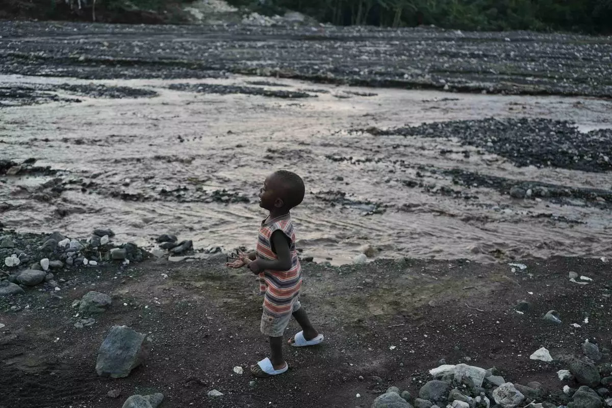 A child walks on the banks of La Digue River in the aftermath of Hurricane Melissa in Petit-Goave, Haiti, Thursday, Nov. 6, 2025. (AP Photo/Odelyn Joseph)