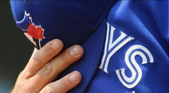 Aug 27, 2015; Arlington, TX, USA; The hat and jersey of Toronto Blue Jays catcher Josh Thole (22) during National Anthem prior to game against the Texas Rangers at Globe Life Park in Arlington. Rangers won 4-1. Mandatory Credit: Ray Carlin-Imagn Images