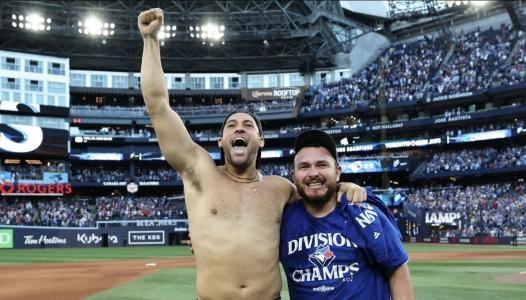 Toronto Blue Jays George Springer and Alejandro Kirk celebrate winning the Al East division at Rogers Centre.